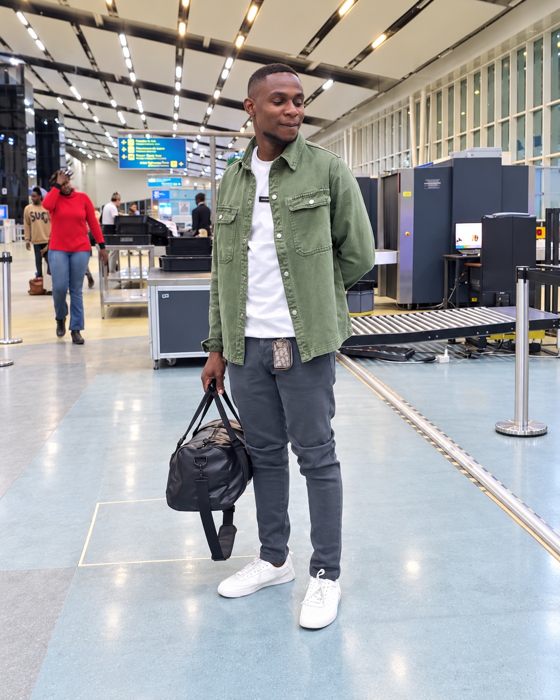 A traveler carrying a bag at an airport